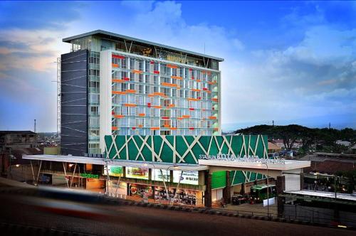 a large building with a green and white at Ascent Premiere Hotel and Convention in Malang