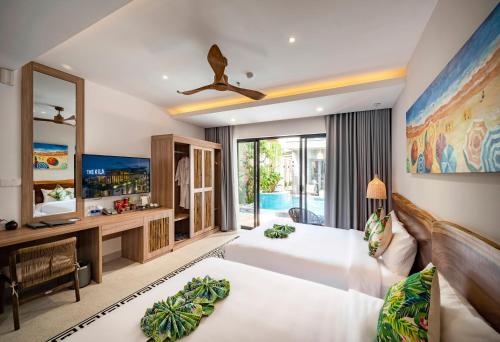 a bedroom with a large bed and a tv at The Kila Boutique Hotel in Quy Nhon