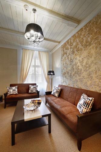 a living room with a couch and a table at Hotel Lippert in Prague