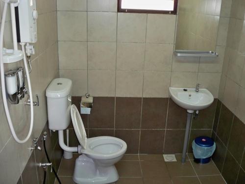 a bathroom with a toilet and a sink at UK FARM Agro Resort in Kluang