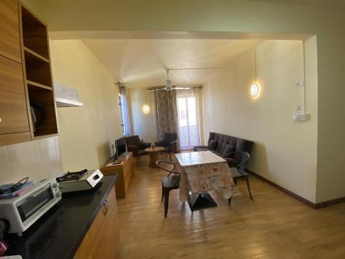 a kitchen and living room with a table and chairs at The Monalysa Suites & Residence in Grand Baie