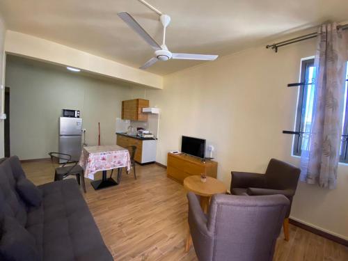 a living room with a couch and chairs and a table at The Monalysa Suites & Residence in Grand Baie