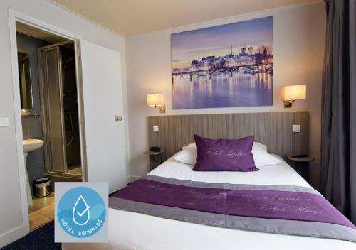 a bedroom with a bed with a purple pillow at Saphir Grenelle in Paris