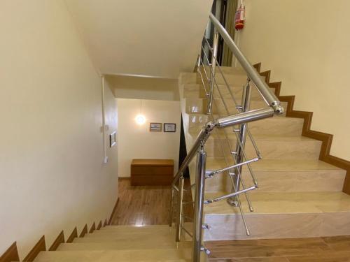 a staircase in a building with a metal railing at The Monalysa Suites & Residence in Grand Baie