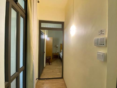 a hallway with a door leading to a room at The Monalysa Suites & Residence in Grand Baie