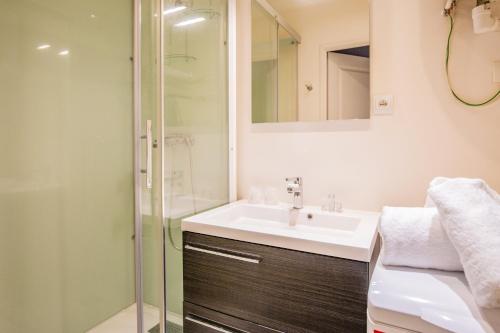 a bathroom with a sink and a shower at Appart'Hotel Saint-Michel in Chartres