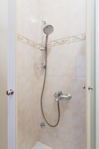 a shower with a shower head in a bathroom at Apartmani Manzoni in Punat