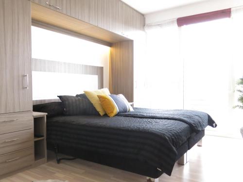 a bedroom with a bed with a window at ApartmentInCopenhagen Apartment 427 in Copenhagen