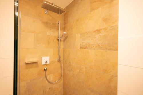 a shower with a glass door in a bathroom at Ferienwohnung Carmen Schuchter in Vandans