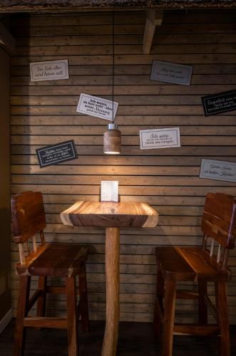 a table and two chairs in a room with signs on the wall at Apartment Central Leipzig - City in Leipzig