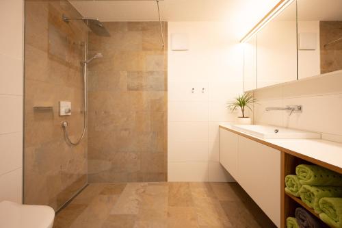 a bathroom with a shower and a sink at Ferienwohnung Carmen Schuchter in Vandans
