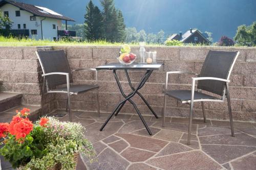 a table and two chairs on a patio at Ferienwohnung Carmen Schuchter in Vandans