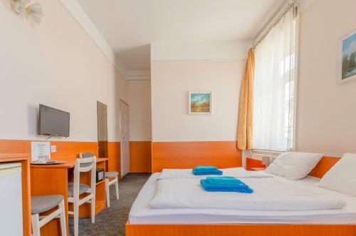 ein Hotelzimmer mit einem Bett und einem Schreibtisch in der Unterkunft Eitans Guesthouse in Budapest