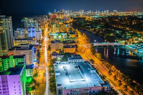 a city at night with a river and buildings at Holiday Inn Miami Beach-Oceanfront by IHG in Miami Beach