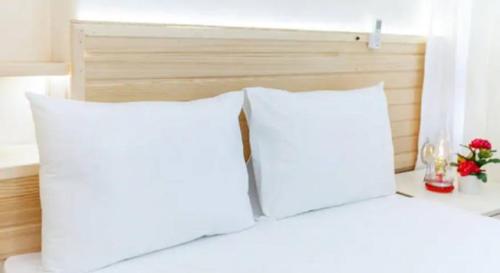 a white bed with pillows and pillows on top of it at Otantik Guesthouse in Istanbul