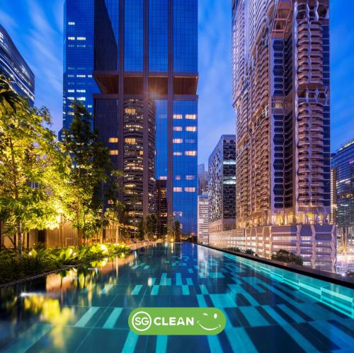 a swimming pool in a city at night at Dao by Dorsett AMTD Singapore in Singapore