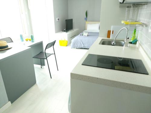 a kitchen with a sink and a counter top at ARA Palace Hotel in Jeju