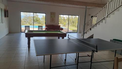 a living room with two ping pong tables in it at Barton Luxury Villas in Botrivier