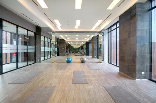 an empty hallway with large windows and a large room with yoga mats at Kokoon Hotel Banyuwangi in Banyuwangi