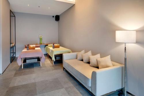a living room with a couch and a table at Kokoon Hotel Banyuwangi in Banyuwangi