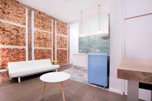 a living room with a brick wall at Fancy One-bedroom La Latina in Madrid