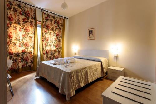 a bedroom with a bed and a table in it at Porta della Musa in Ascoli Piceno