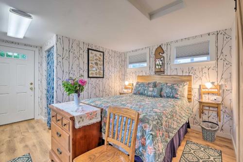 a bedroom with a bed and a chair and a table at Historic Cottage on Horse Farm FirePit and BBQ in Milbridge