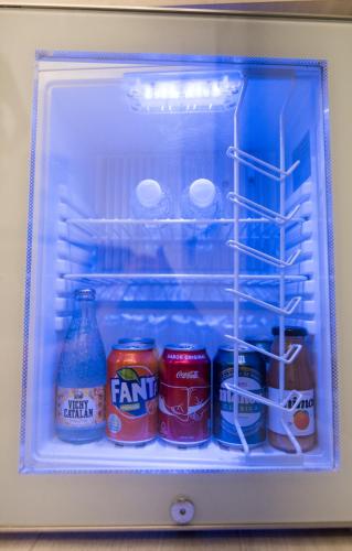 a refrigerator filled with drinks and cans of soda at Rambla Alicante Contactless in Alicante