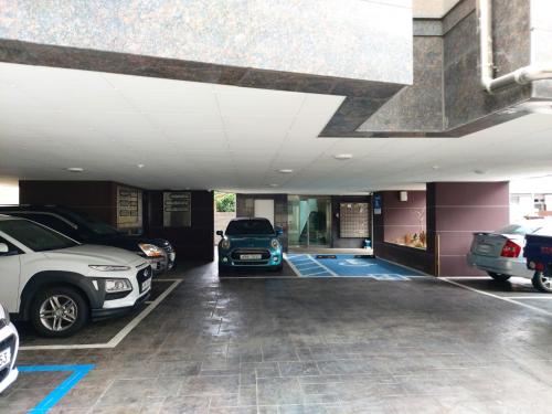 a garage with several cars parked in it at ARA Palace Hotel in Jeju