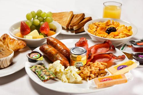 a table with plates of breakfast food on it at ibis Aberdeen Centre – Quayside in Aberdeen
