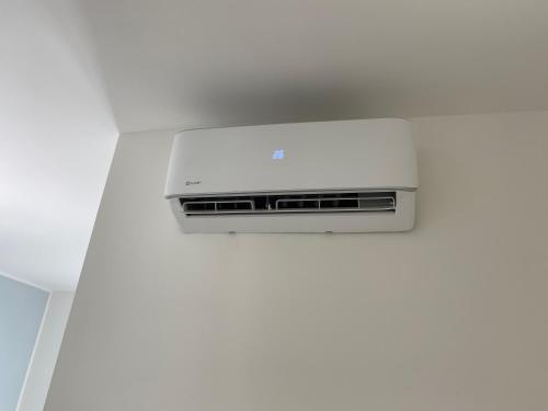 a white air conditioner in a white wall at Stadio 1 - Appartamenti monolocali con bagno privato Verona in Verona