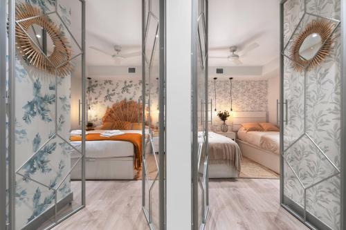 two views of a bedroom with a bed and a mirror at 2 bedrooms 1 bathroom furnished - Justicia - Executive style - MintyStay in Madrid