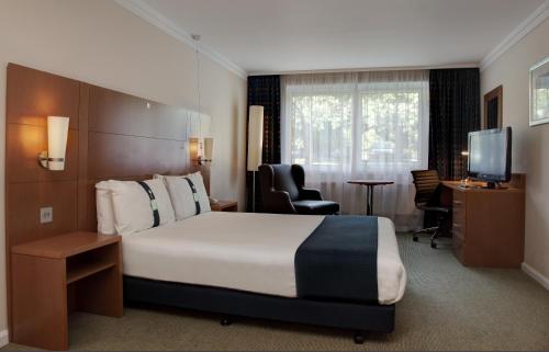 a hotel room with a bed and a desk at Holiday Inn Brentwood, an IHG Hotel in Brentwood