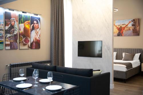 a living room with a couch and a table with wine glasses at Prime Suites Bulvar in Baku