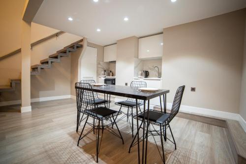 a kitchen and dining room with a table and chairs at Prime Suites Bulvar in Baku