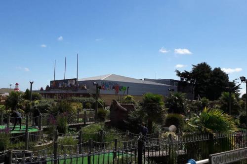 a garden in front of a building with graffiti at Mablethorpe Static Holiday Home in Mablethorpe