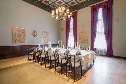 a large room with a table with chairs and a chandelier at Radisson Blu Grand Hotel Tammer in Tampere