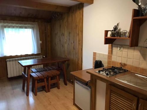 cocina con mesa y fogones horno superior en Domek pod Skocznią en Zakopane