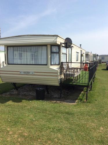 an rv is parked in a grass field at L&g caravan hire 4 BERTH CORAL BEACH GEN FAMILYS ONLY AND LEAD PERSON MUST BE OVER 30 in Ingoldmells