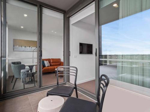 a room with sliding glass doors and a living room at The Sebel Melbourne Moonee Ponds in Melbourne