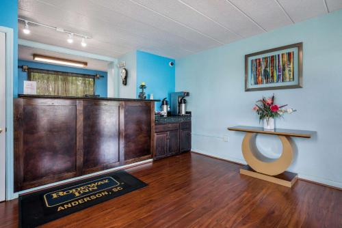 a waiting room with a counter and a table at Rodeway Inn in Anderson