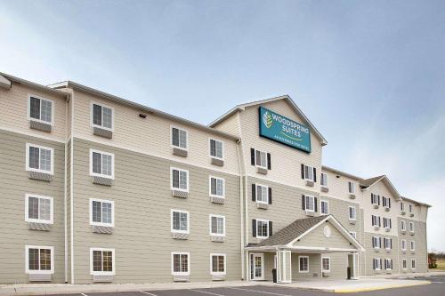 a large building with a sign on the side of it at WoodSpring Suites Manassas Battlefield Park I-66 in Manassas