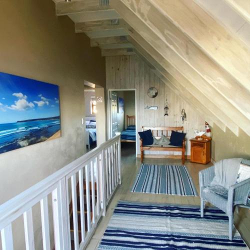 a staircase in a house with a view of the ocean at Kaiha (Witsand, Western Cape) in Witsand