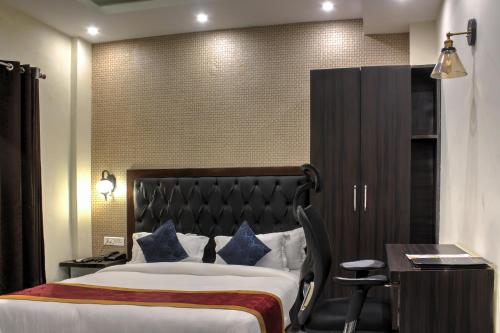 a hotel room with a bed and a desk at HOTEL HILL VIEW in Dehradun
