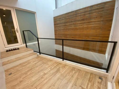a staircase in a house with a glass and wood wall at Hygge Kro in Hualien City