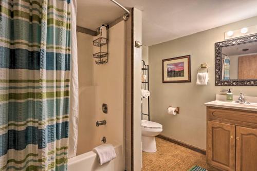 a bathroom with a tub and a toilet and a sink at Riverfront Townsend Apt - 18 Miles to Pigeon Forge in Townsend