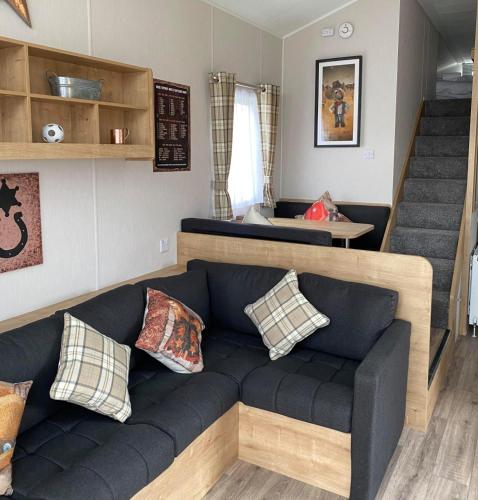 a living room with a couch and a staircase at Gulliver's Valley, M1, JCT 31 in Rotherham