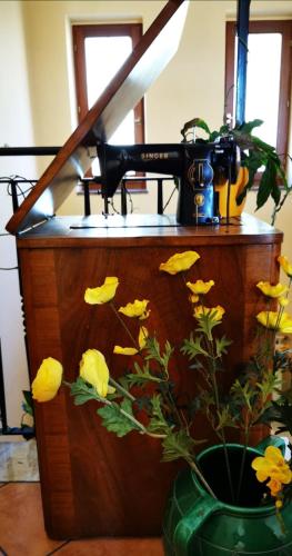 a counter with a camera and a vase with yellow flowers at mansarda fiorita in Abatemarco