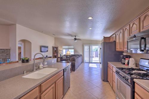 a large kitchen with a sink and a stove at Inviting Retreat with Patio Less Than 1 Mi to Colorado River in Bullhead City