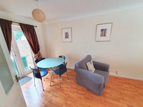 a living room with a table and a couch at Friars Walk houses with 2 bedrooms, 2 bathrooms, fast Wi-Fi and private parking in Sittingbourne